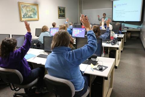 over the shoulder view of students in a computer workshop class