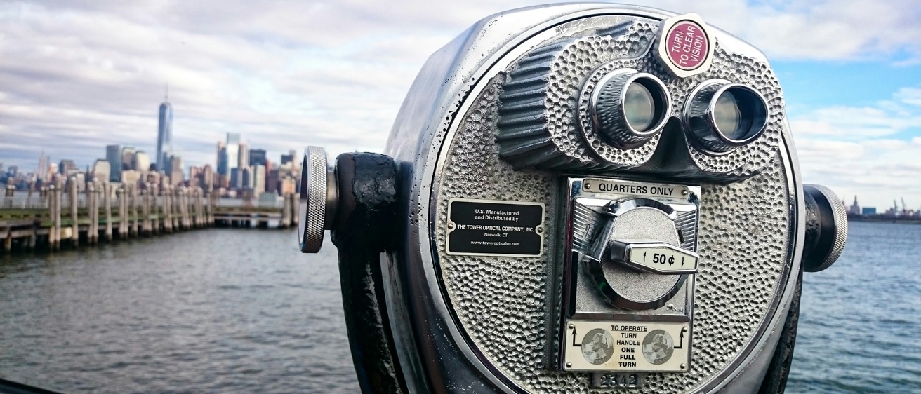 Sightseeing binoculars with cityscape in the background